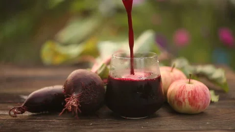 Beet-apple  juice in glass on  table Stock Footage 102629632