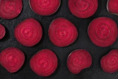 Beet flat lay pattern. Beetroot, shot from the top on a black background, cut Stock Photos