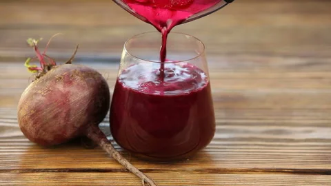 Beet juice in glass on  table Stock Footage 101846656