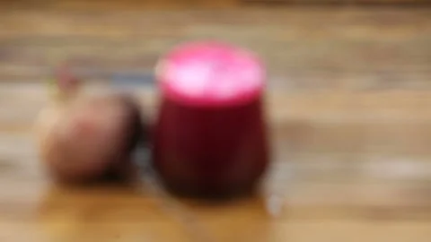 Beet juice in glass on  table Stock Footage 101946181