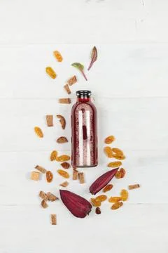 Beet kvass in a serving bottle, on a light wooden background with pieces of Stock Photos