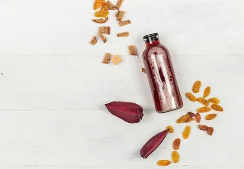 Beet kvass in a serving bottle, on a light wooden background with pieces of Stock Photos