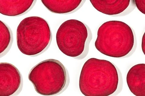 Beet pattern, vibrant red slices, shot from above on a white background, a flat Stock Photos