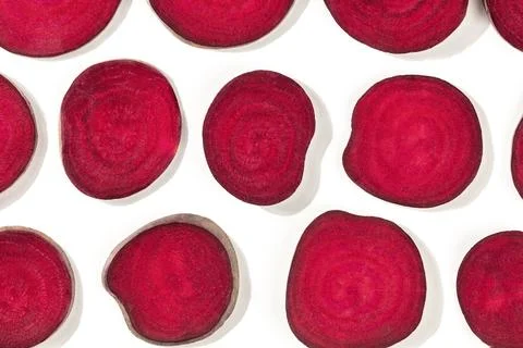 Beet pattern, vibrant red slices, shot from above on a white background, a flat Stock Photos