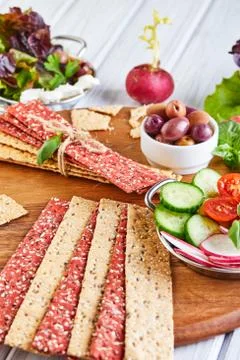 Beetroot and rye flour crackers with vegetables for making snacks on a wooden Stock Photos