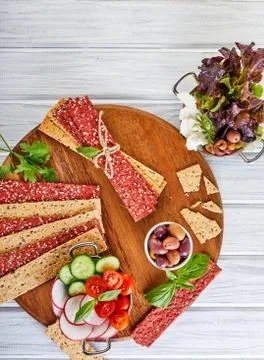 Beetroot and rye flour crackers with vegetables for making snacks on a wooden Stock Photos