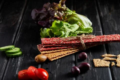 Beetroot and rye flour crackers with vegetables for making snacks on a blac.. Stock Photos