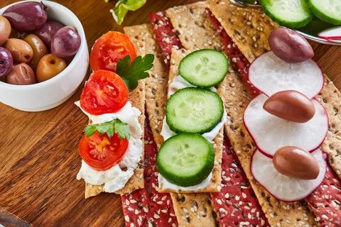 Beetroot and rye flour crackers with vegetables for making snacks on a wood.. Stock Photos