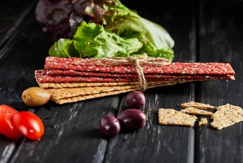 Beetroot and rye flour crackers with vegetables for making snacks on a blac.. Stock Photos