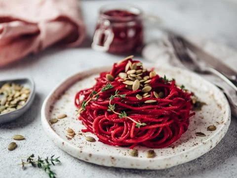 Beetroot and thyme spaghetti with pumpkin seed 스톡 사진