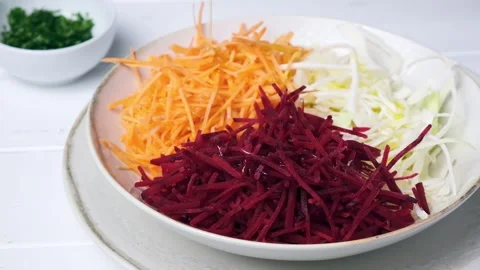 Beetroot, carrot, cabbage salad with oil and herbs, gray background. Stock Footage 149506663