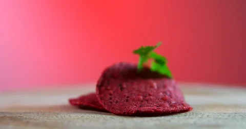 Beetroot chips and parsley on the cutting board isolated on red background Video stock 91633188