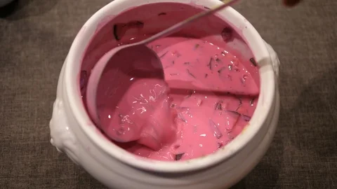 Beetroot cold Soup stirring in Bowl with Spoon. Ready to eat. Isolated close-up. Stock Footage 124873650