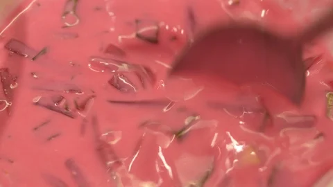 Beetroot cold Soup stirring in Bowl with Spoon. Ready to eat. Isolated Macro Stock Footage 124873885