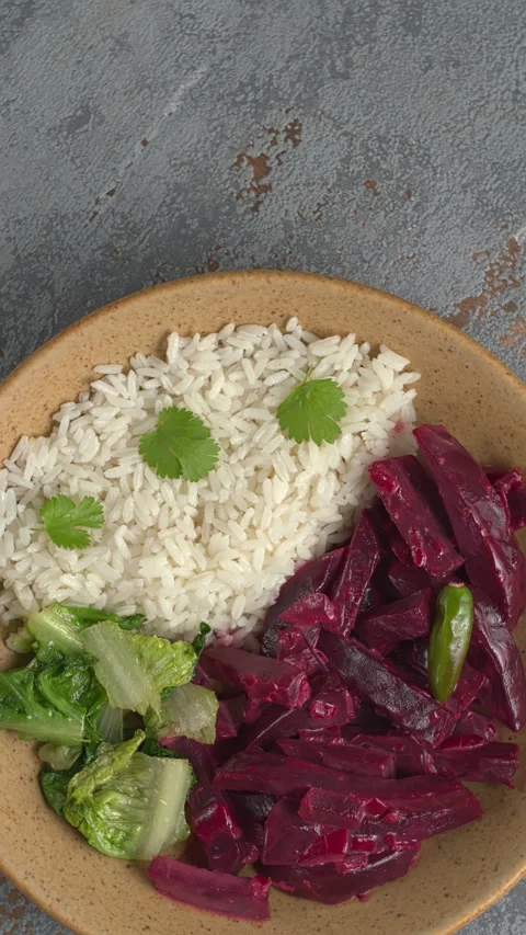 Beetroot curry with rice and stir-fried lettuce. Copy space. Vertical video. Stock Footage 283728844