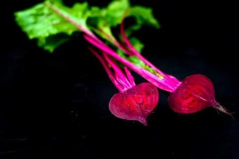 Beetroot cut in half on a black background, place for text, healthy food Copy Stock Photos