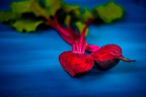 Beetroot cut in half on a blue background, place for text, healthy food Copy  Stock Photos