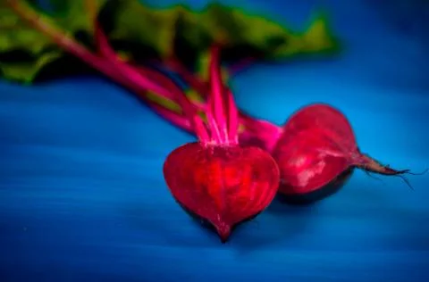 Beetroot cut in half on a blue background, place for text, healthy food Copy Stock Photos