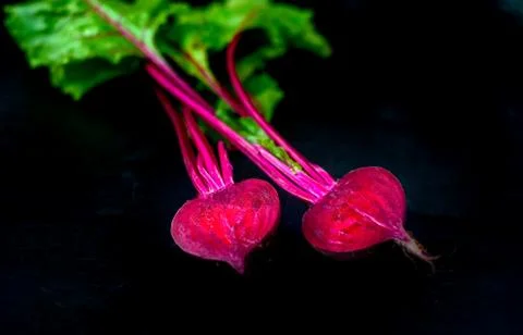 Beetroot cut in half on a dark background, place for text, healthy food Photos
