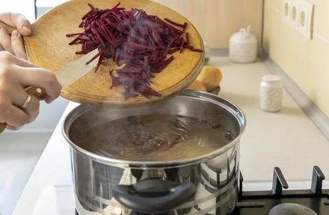 Beetroot, cut into strips, is added to a pot to make borsch, a Ukrainian Stock Photos