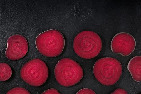 Beetroot design layout. Slices of beet, shot from the top on a black background Foto stock
