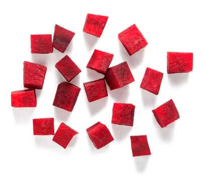 Beetroot diced in medium cubes on white background Stock Photos