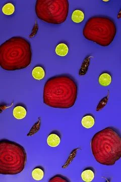 Beetroot in the form of a pattern with lemon slices on a pink background Stock Photos