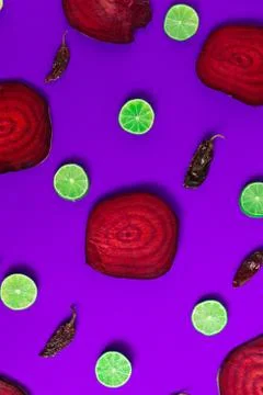 Beetroot in the form of a pattern with lemon slices on a pink background Stock Photos