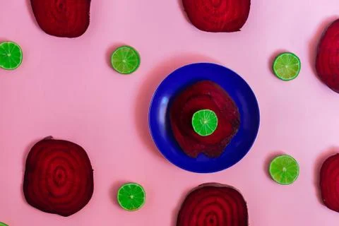 Beetroot in the form of a pattern with lemon slices on a purple background Stock Photos