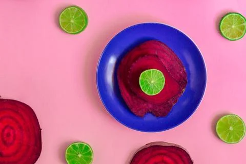 Beetroot in the form of a pattern with lemon slices on a purple background Stock Photos