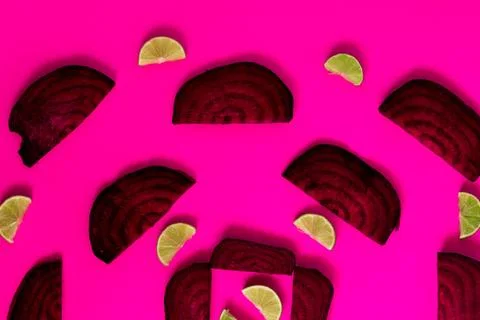 Beetroot in the form of a pattern with lemon slices on a pink background Stock Photos