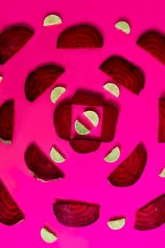 Beetroot in the form of a pattern with lemon slices on a purple background Stock Photos
