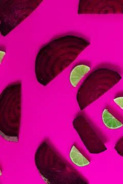 Beetroot in the form of a pattern with lemon slices on a purple background Stock Photos