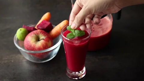 Beetroot juice with carrot and apple in a glass on a black background. Stock Footage 212358318