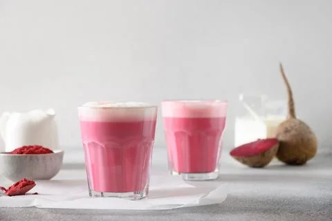 Beetroot latte or pink moon milk latte in cup on gray background. Great war.. Stock Photos