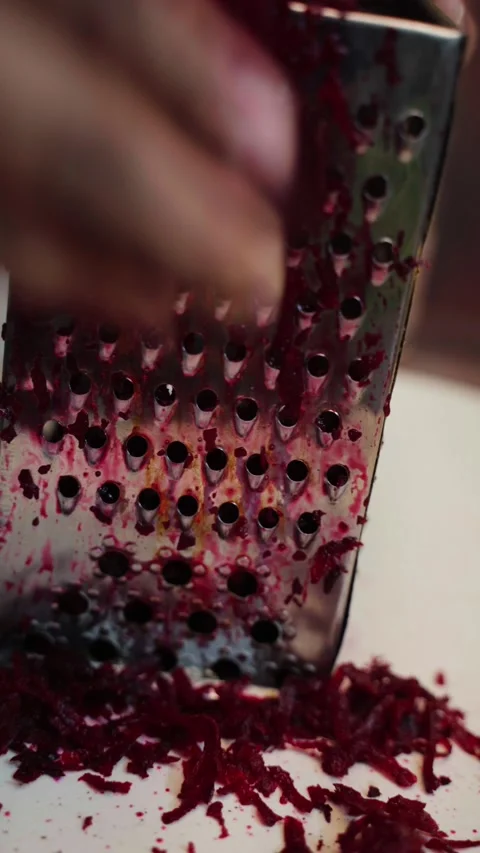 Beetroot peeling on a board. beetroot peeling through a stainless steel grater. Stock Footage 283361799