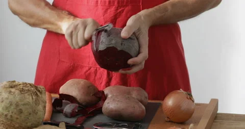 Beetroot peeling using vegetable peeler Stock Footage 147513212