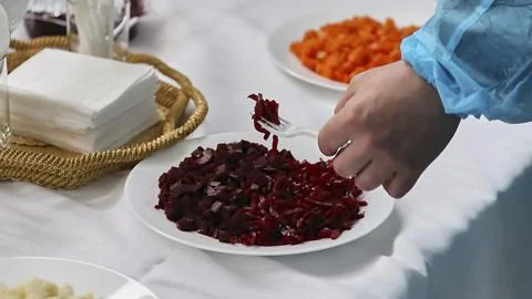 Beetroot salad for tasting. hand with fork serving salad. Stock Photos