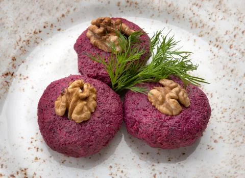 Beetroot salad with walnuts on a plate Stock Photos