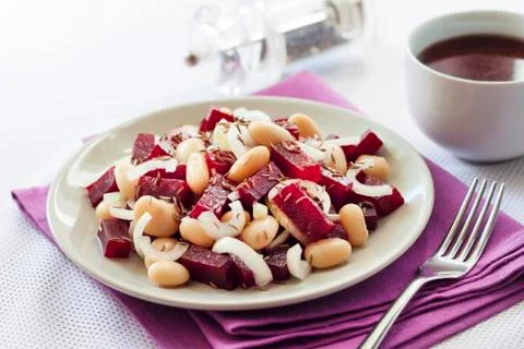 Beetroot salad with white kidney beans, pickles and onion Stock Photos