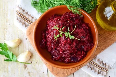 Beetroot saute with onions and tomatoes garlic and olive oil in a brown bowl Stock Photos