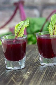 Beetroot shots on wooden table Stock Photos