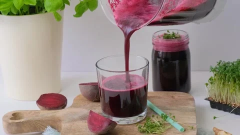 Beetroot smoothie is poured into a glass. Beetroot smoothie Stock Footage 263047902