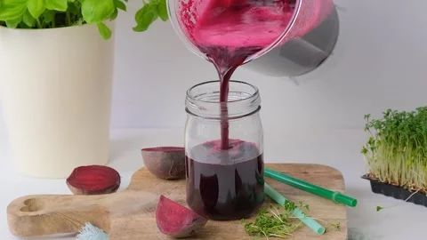 Beetroot smoothie is poured into a glass. Beetroot smoothie Stock Footage 263047910