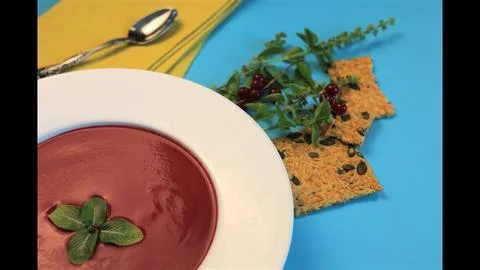 Beetroot soup with seeded crackers delivers vibrant red and gold tones. Clean Stock Photos