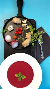 Beetroot soup with smooth texture garnished with fresh herbs, cherry tomatoes Stock Photos