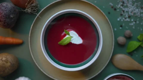 Beetroot soup, topped with strained yogurt and fresh mint. Top view. Video stock 231554910