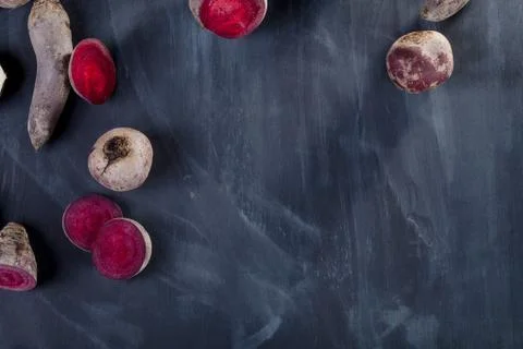 Beetroots lying on blackboard Stock Photos