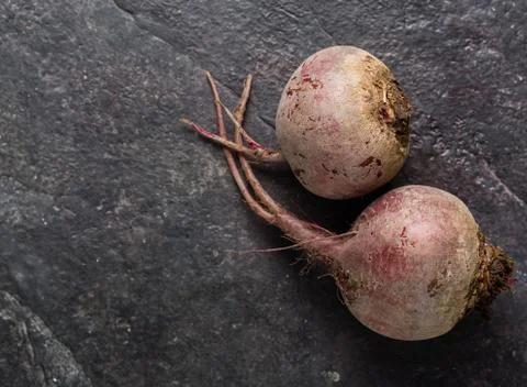 Beets on a black stone background. Stock Photos