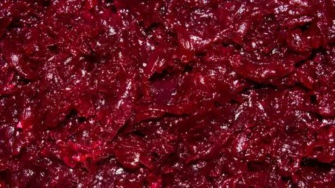 Beets boiled grated.Background of beets grated on a coarse grater. Stock Photos